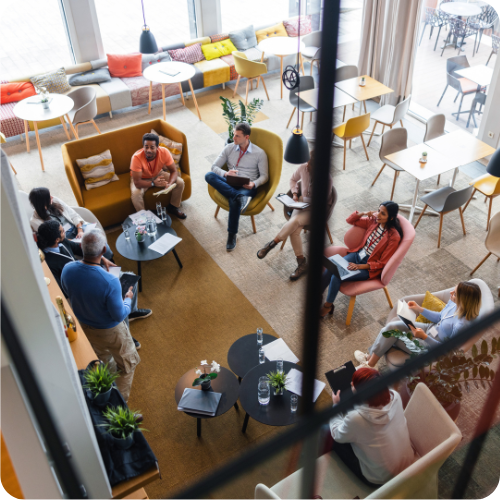 A group of people seated in a circle in an office, reflecting ARKK's commitment to employee well-being, collaboration, and a supportive workplace culture.