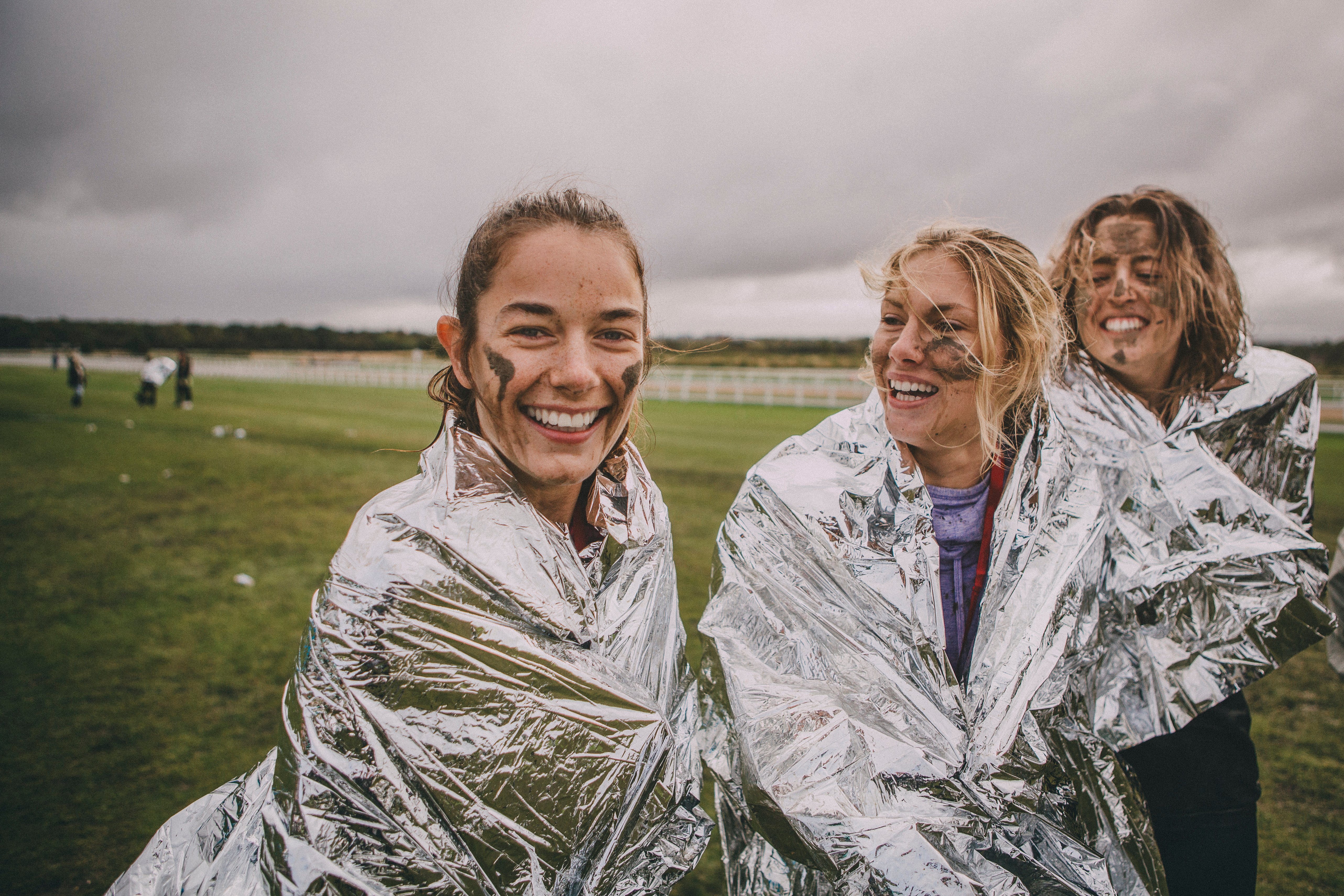 Three smiling women after a run, symbolising the pride takes in supporting charities.